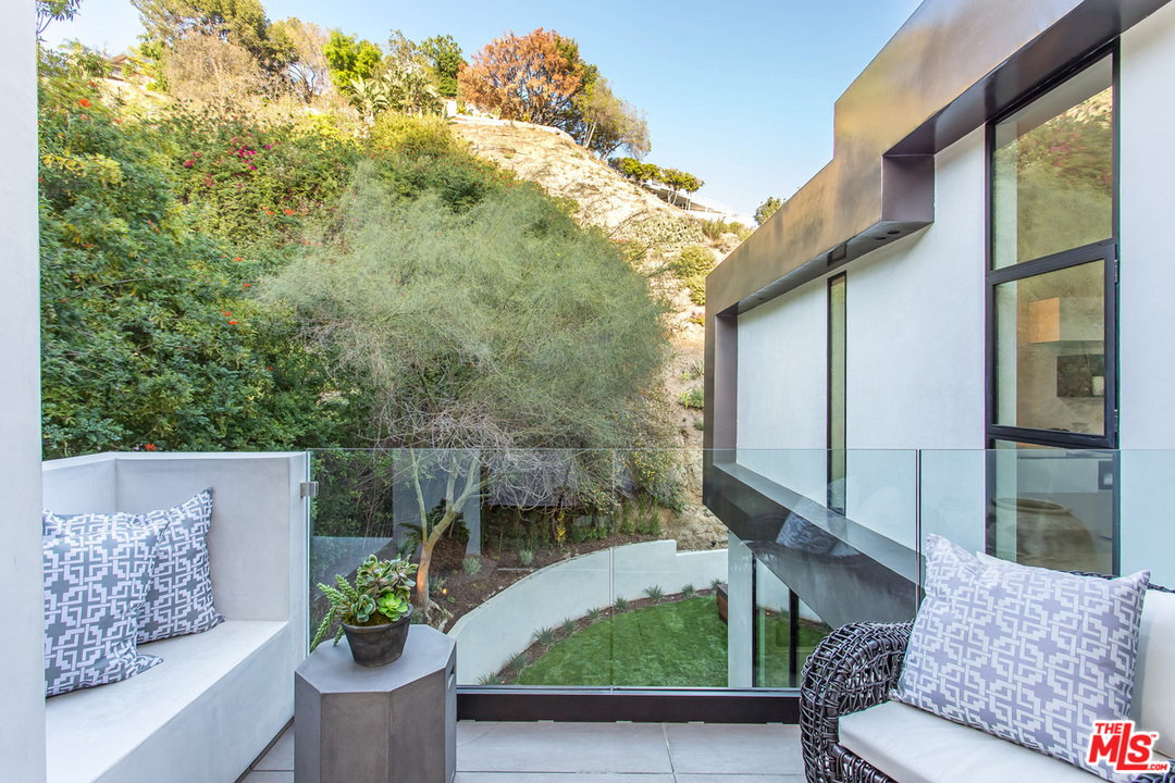 1424 Rising Glen Road Los Angeles, CA 90069 - Photo 40 of 48 a view of a patio with couches table and chairs and potted plants