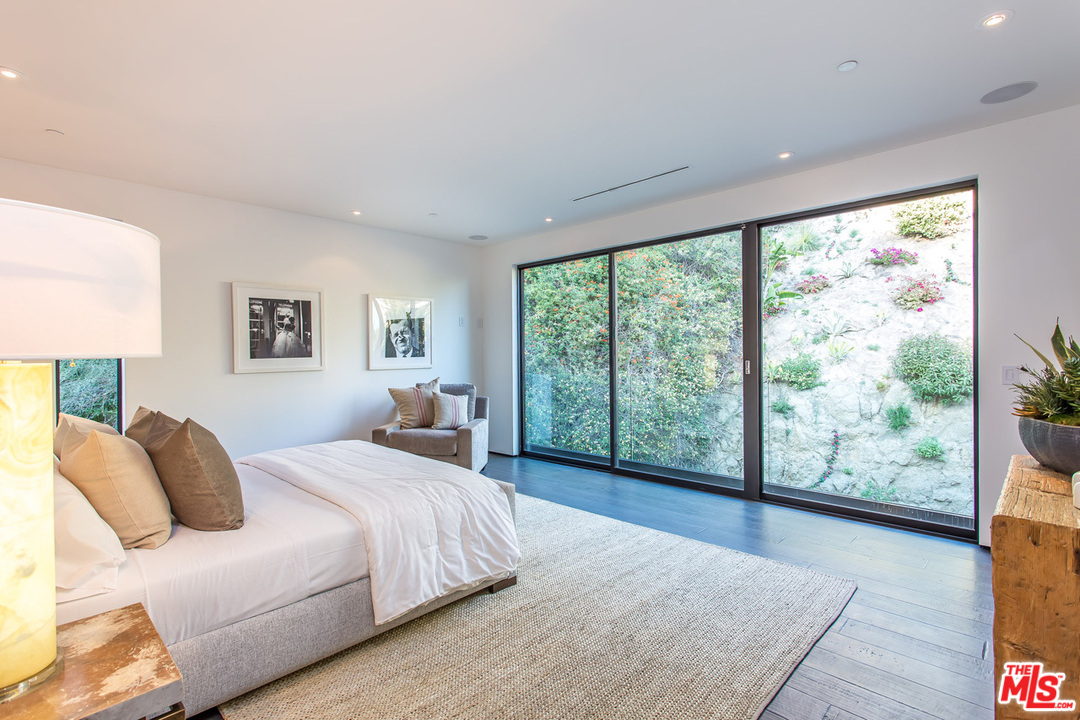 1424 Rising Glen Road Los Angeles, CA 90069 - Photo 41 of 48 a bedroom with a large bed and a large window