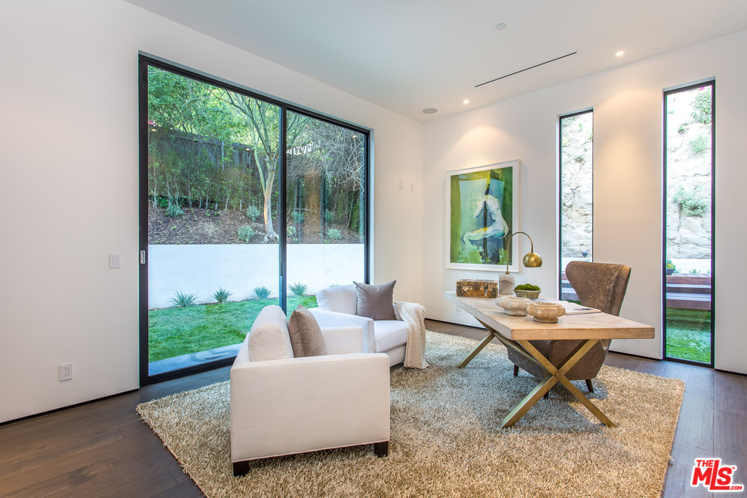 1424 Rising Glen Road Los Angeles, CA 90069 - Photo 44 of 48 a living room with furniture and a floor to ceiling window