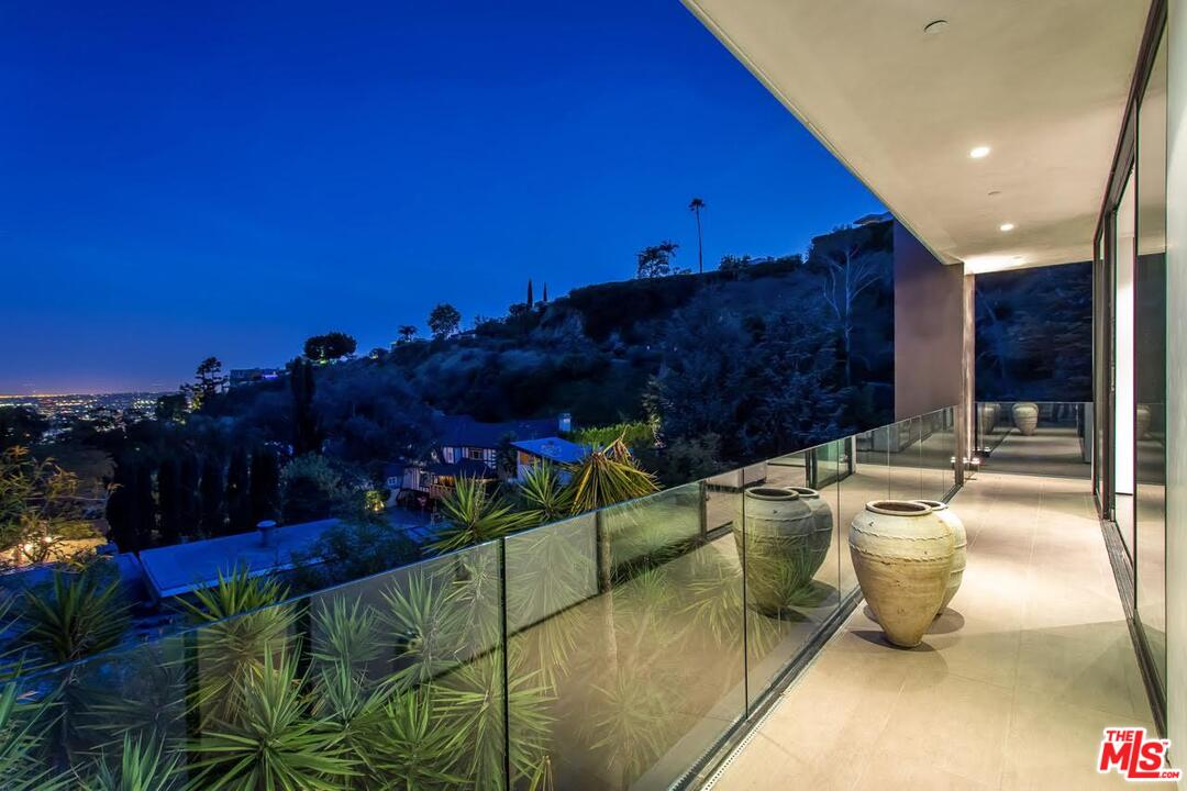 1424 Rising Glen Road Los Angeles, CA 90069 - Photo 47 of 48 a view of a balcony with chairs and a potted plant