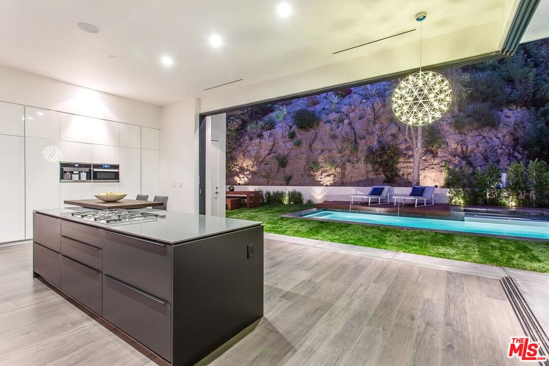 1424 Rising Glen Road Los Angeles, CA 90069 - Photo 7 of 48 a open kitchen with cabinets a stove and a wooden floor