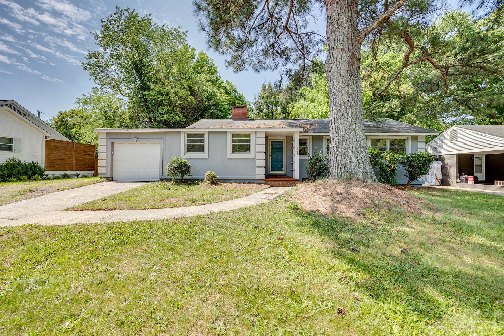 1136 East Woodlawn Road Charlotte, NC 28209 - Photo 1 of 27 a view of a house with backyard and trees