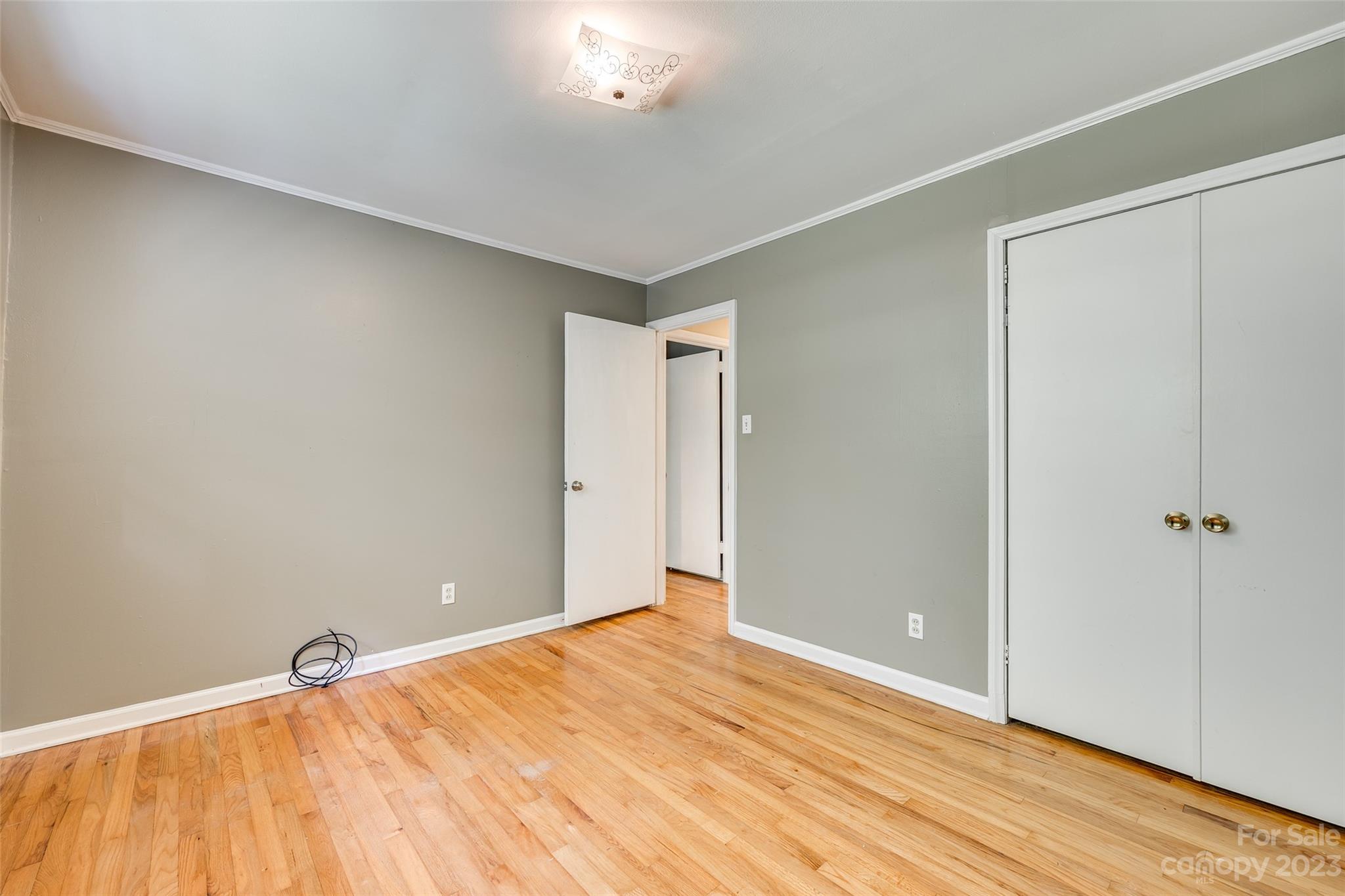 1136 East Woodlawn Road Charlotte, NC 28209 - Photo 12 of 27 a view of an empty room and wooden floor
