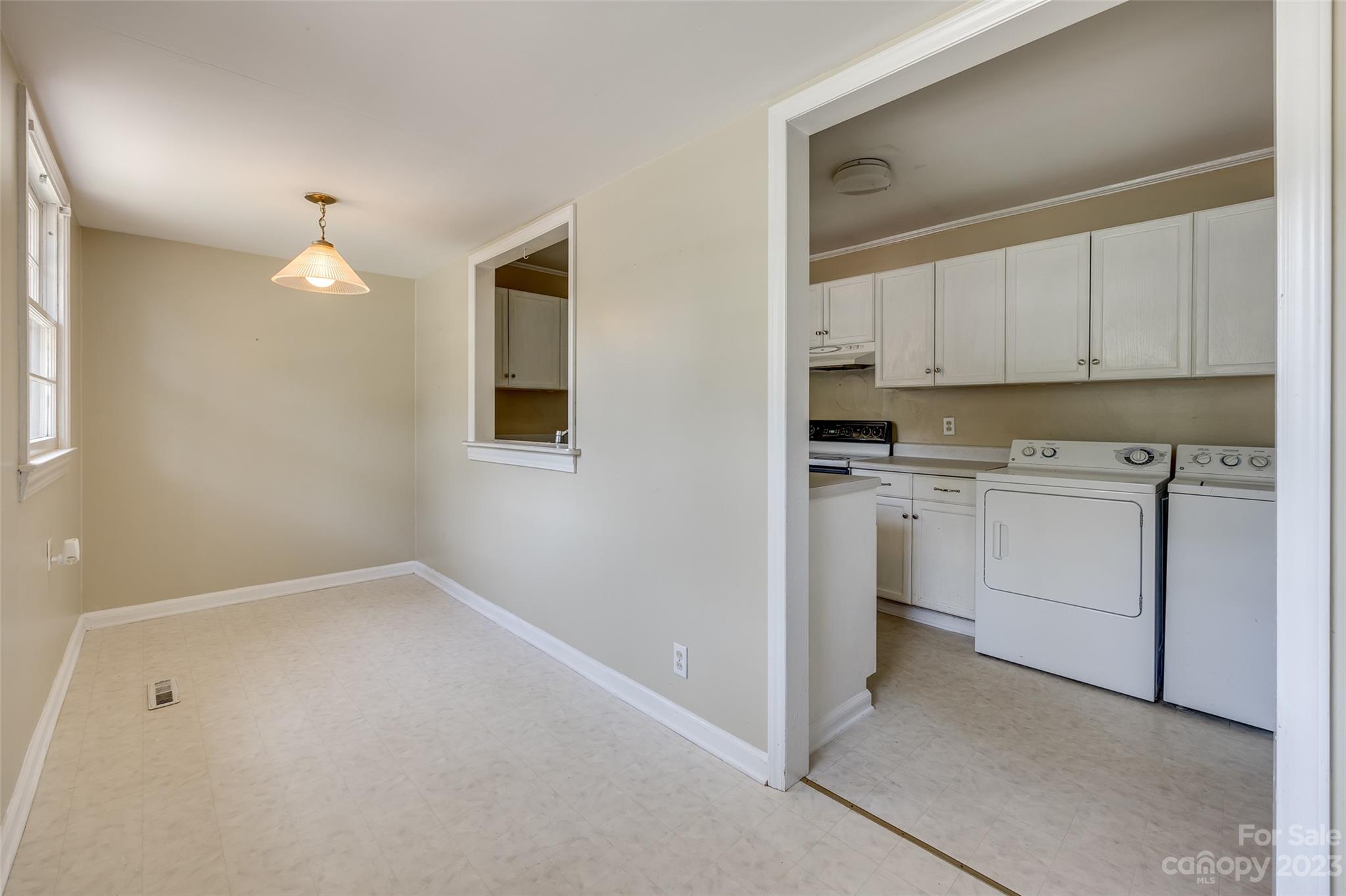 1136 East Woodlawn Road Charlotte, NC 28209 - Photo 15 of 27 a kitchen with white cabinets and white appliances