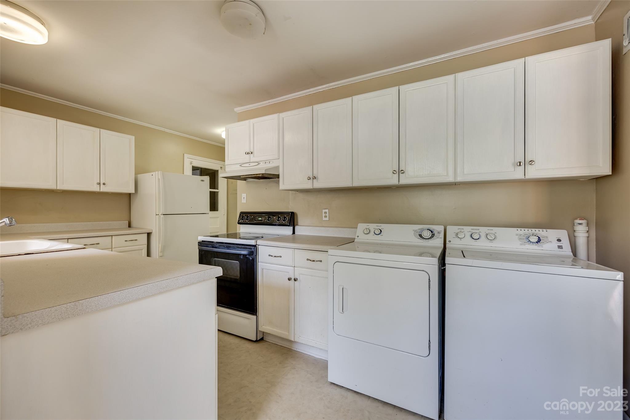 1136 East Woodlawn Road Charlotte, NC 28209 - Photo 16 of 27 a kitchen with cabinets appliances a sink and a counter space