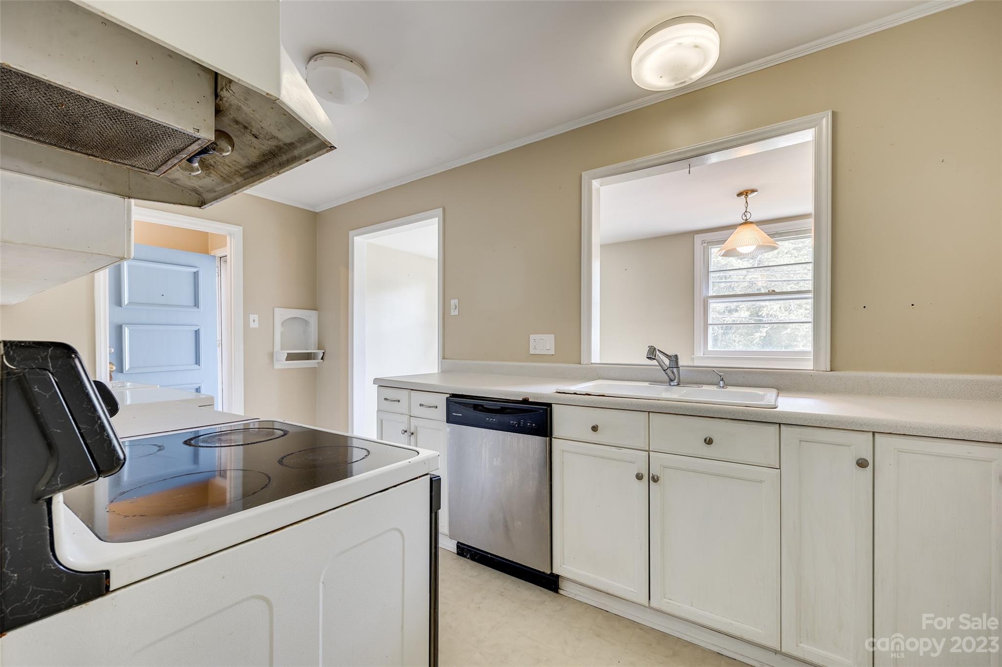 1136 East Woodlawn Road Charlotte, NC 28209 - Photo 17 of 27 a kitchen with white cabinets and sink