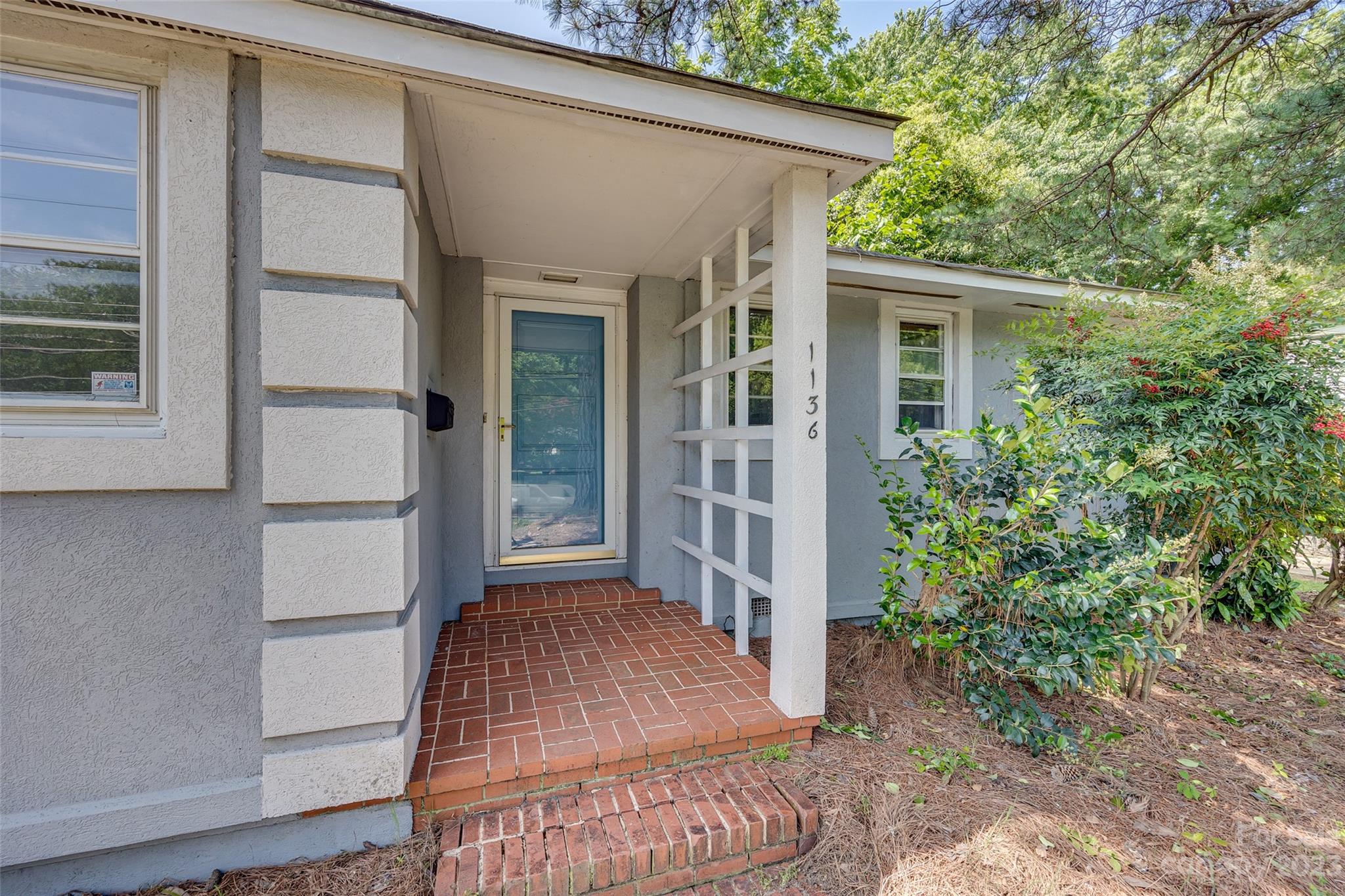 1136 East Woodlawn Road Charlotte, NC 28209 - Photo 2 of 27 front view of a house with a yard