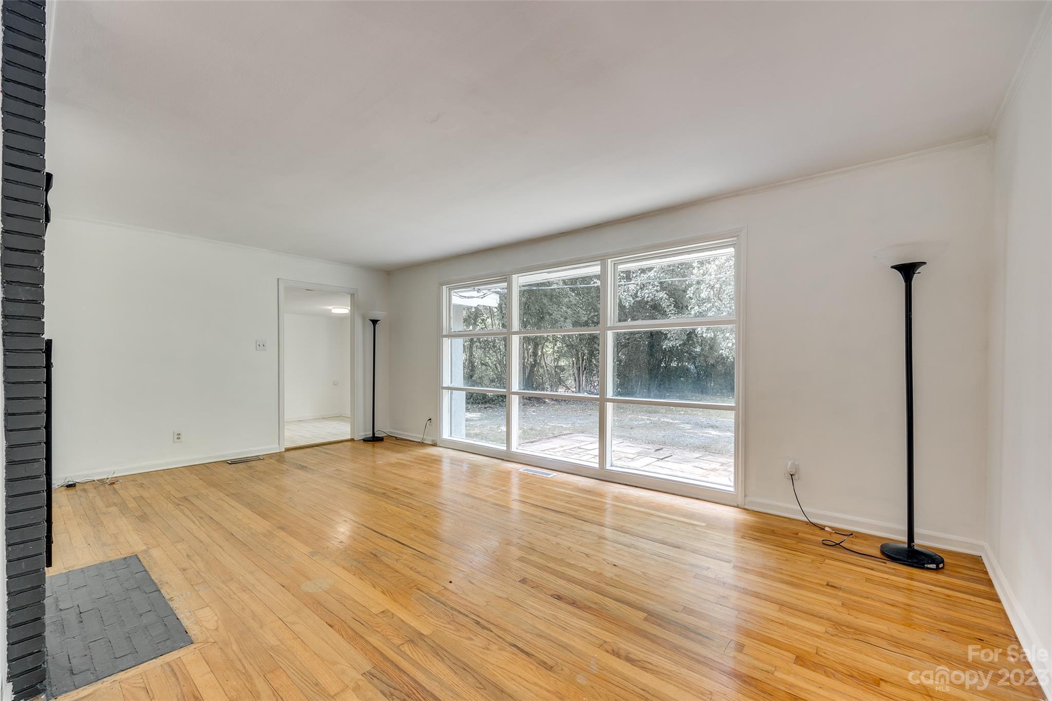 1136 East Woodlawn Road Charlotte, NC 28209 - Photo 22 of 27 a view of an empty room with wooden floor and a window