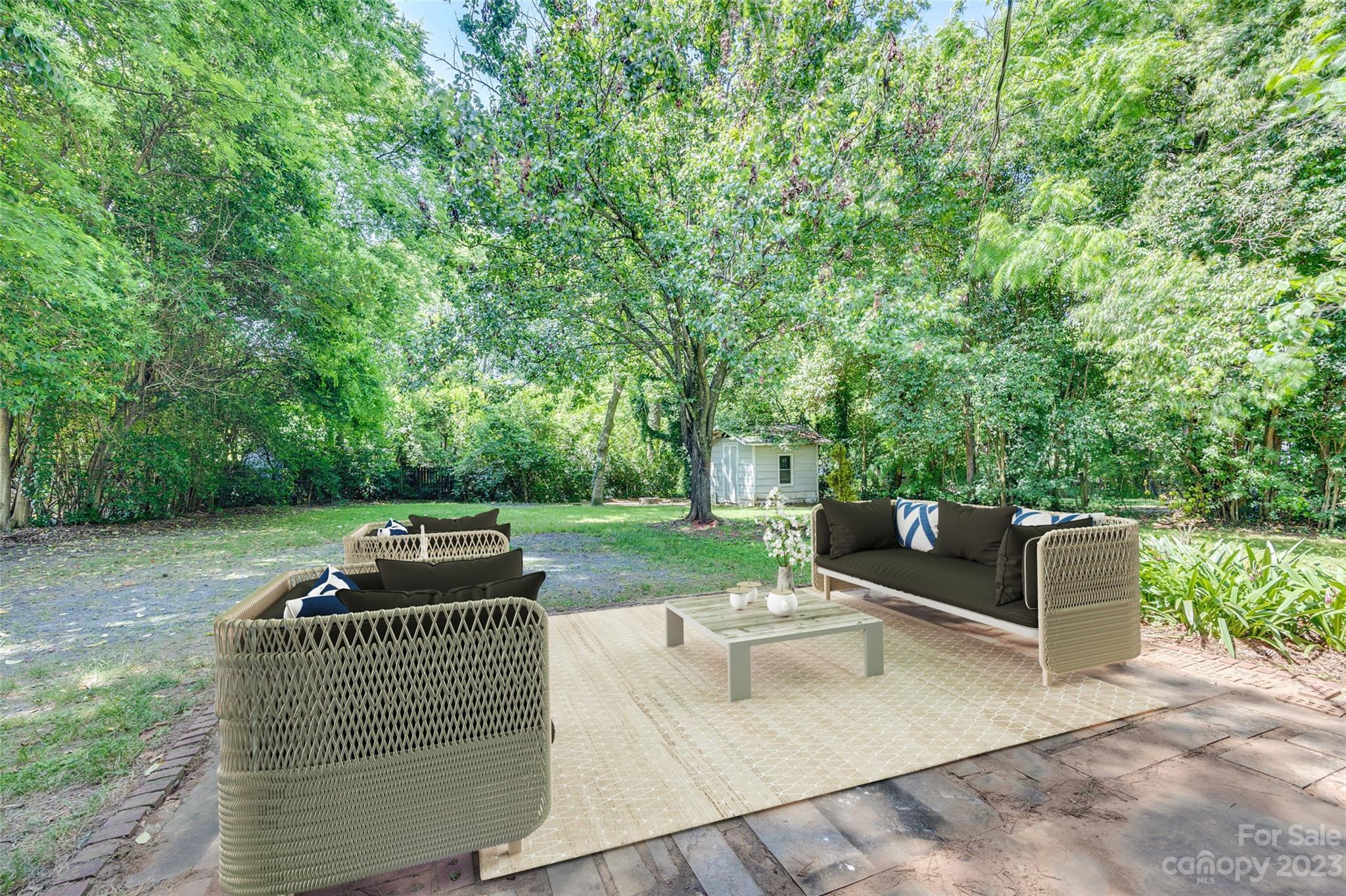 1136 East Woodlawn Road Charlotte, NC 28209 - Photo 23 of 27 a view of a patio with couches and a table and chairs with wooden fence