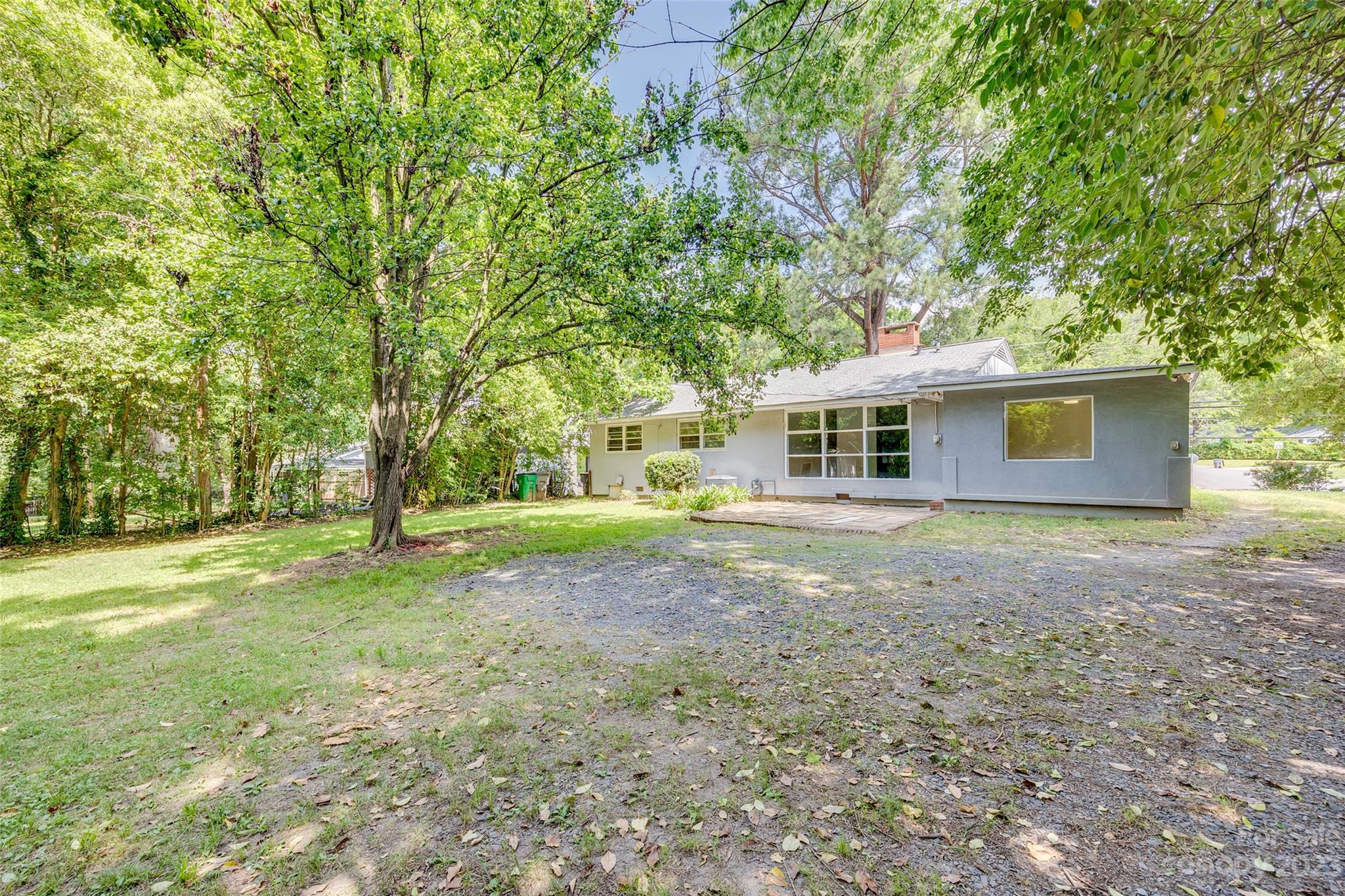 1136 East Woodlawn Road Charlotte, NC 28209 - Photo 26 of 27 a view of a house with backyard and trees