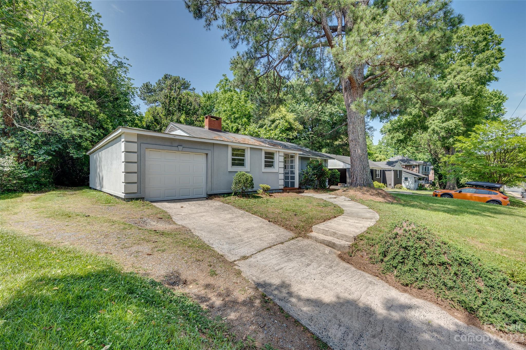 1136 East Woodlawn Road Charlotte, NC 28209 - Photo 27 of 27 a front view of a house with a yard and garage