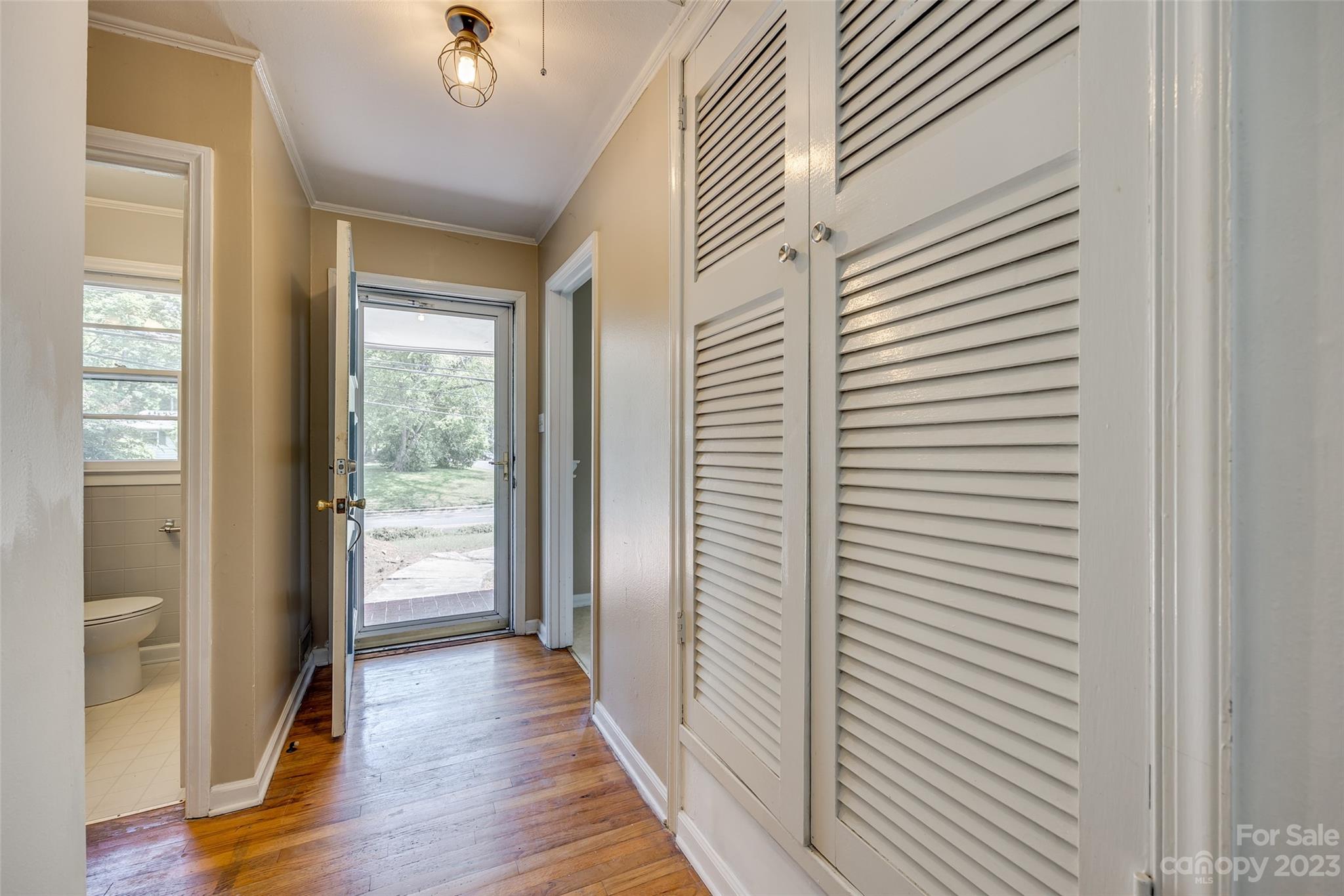 1136 East Woodlawn Road Charlotte, NC 28209 - Photo 3 of 27 a view of a hallway with wooden floor