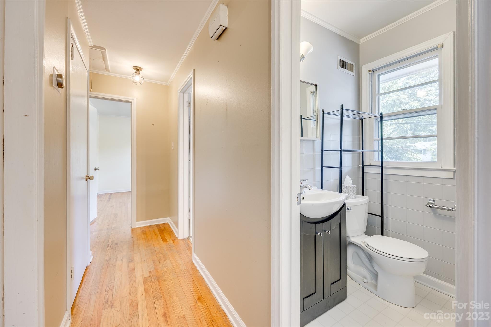 1136 East Woodlawn Road Charlotte, NC 28209 - Photo 4 of 27 a bathroom with a sink and toilet
