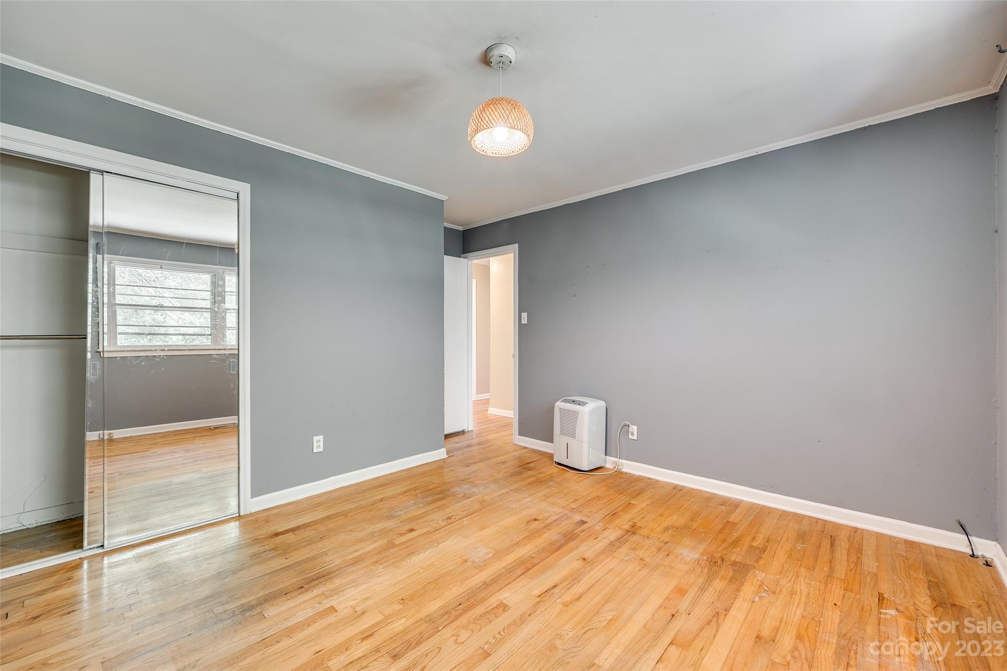 1136 East Woodlawn Road Charlotte, NC 28209 - Photo 10 of 27 an empty room with wooden floor and windows