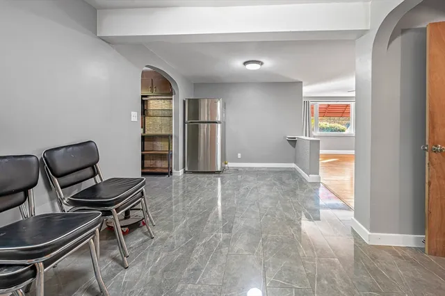 a view of a workspace with furniture and a window