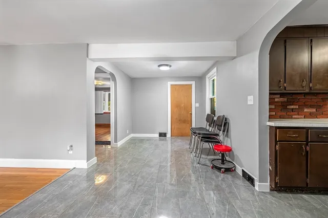 a view of a room with cabinet mirror and windows