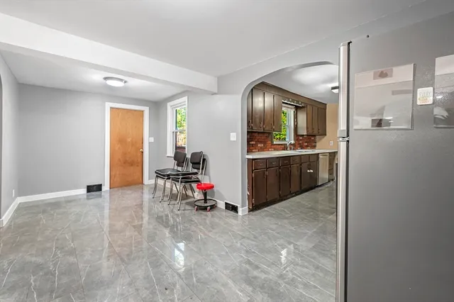 a view of a livingroom with kitchen and workspace