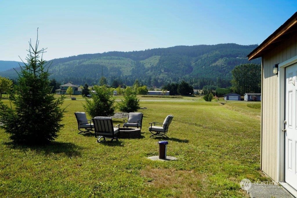 86 Nicki Lane Sequim, WA 98382 - Photo 1 of 1 a view of a swimming pool with a garden and a bench