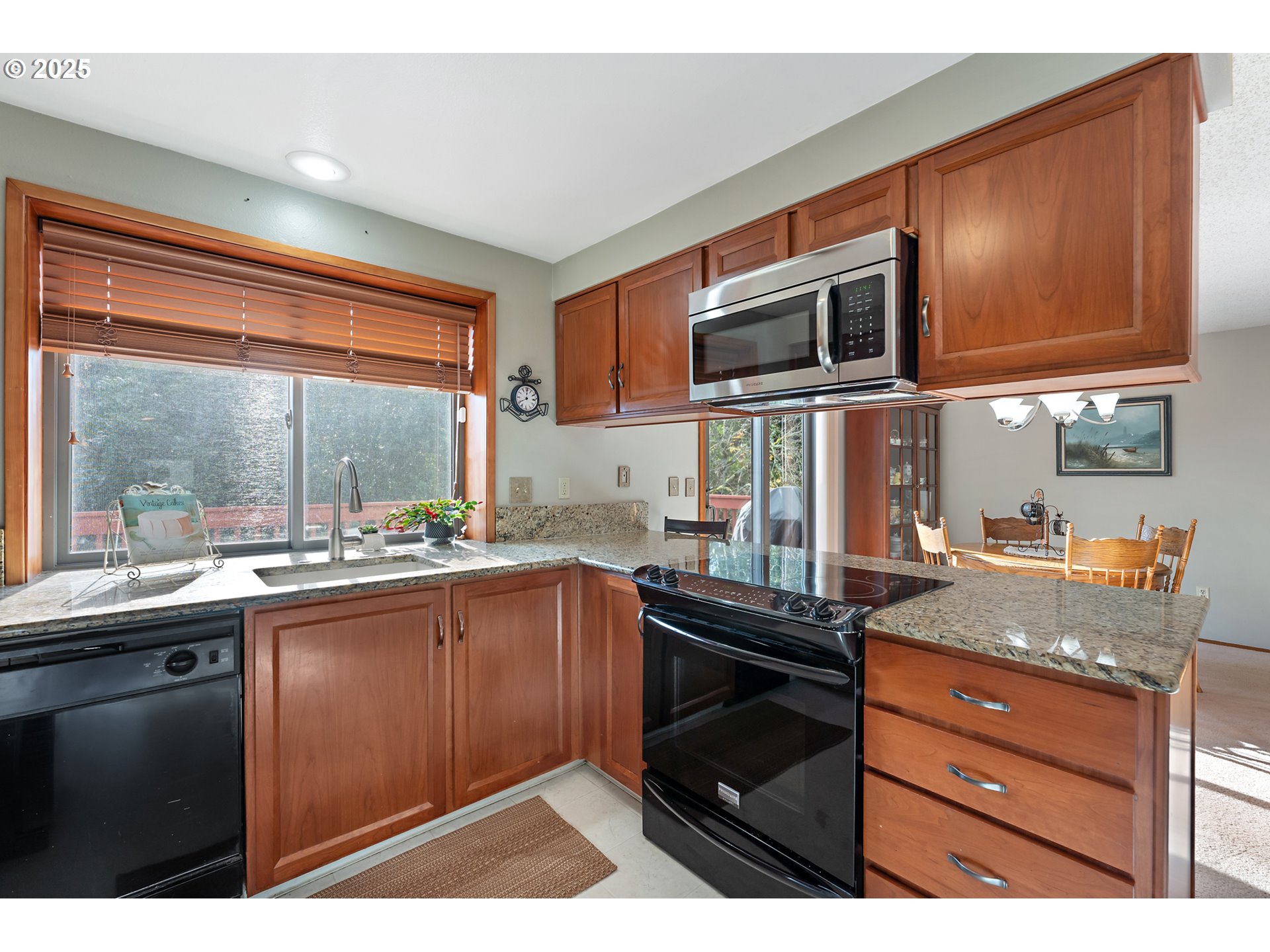 18100 Southwest Barcelona Way Beaverton, OR 97007 - Photo 14 of 41 a kitchen with a sink stove and microwave