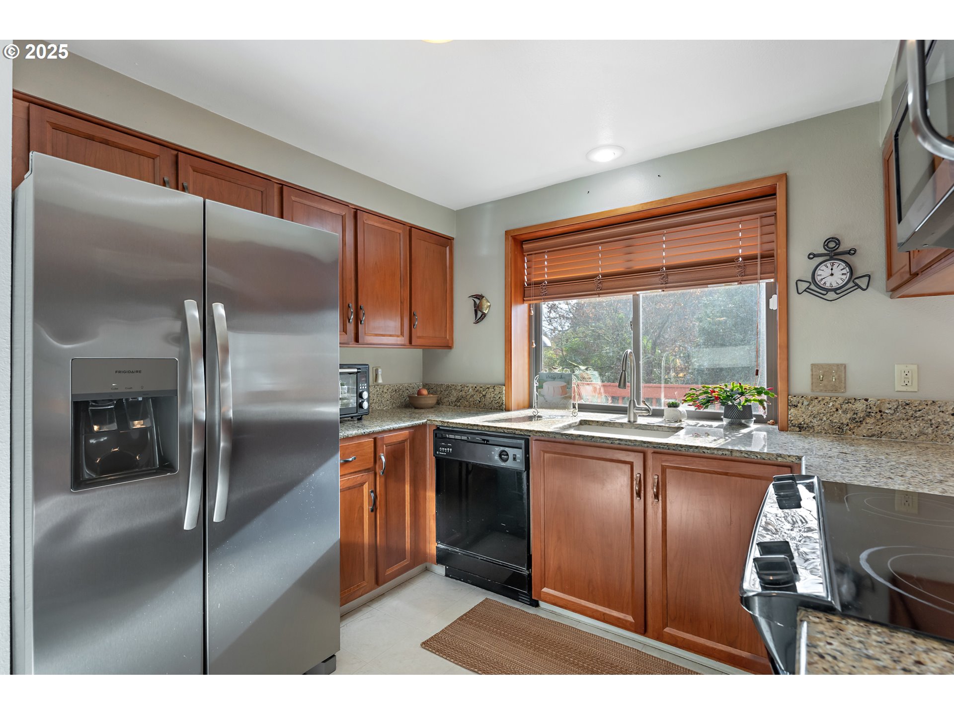 18100 Southwest Barcelona Way Beaverton, OR 97007 - Photo 15 of 41 a kitchen with stainless steel appliances granite countertop a stove a sink and a refrigerator