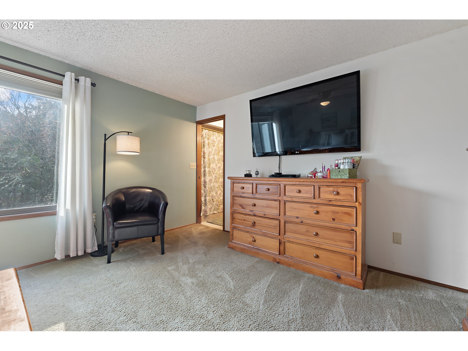 18100 Southwest Barcelona Way Beaverton, OR 97007 - Photo 19 of 41 a living room with furniture and a flat screen tv