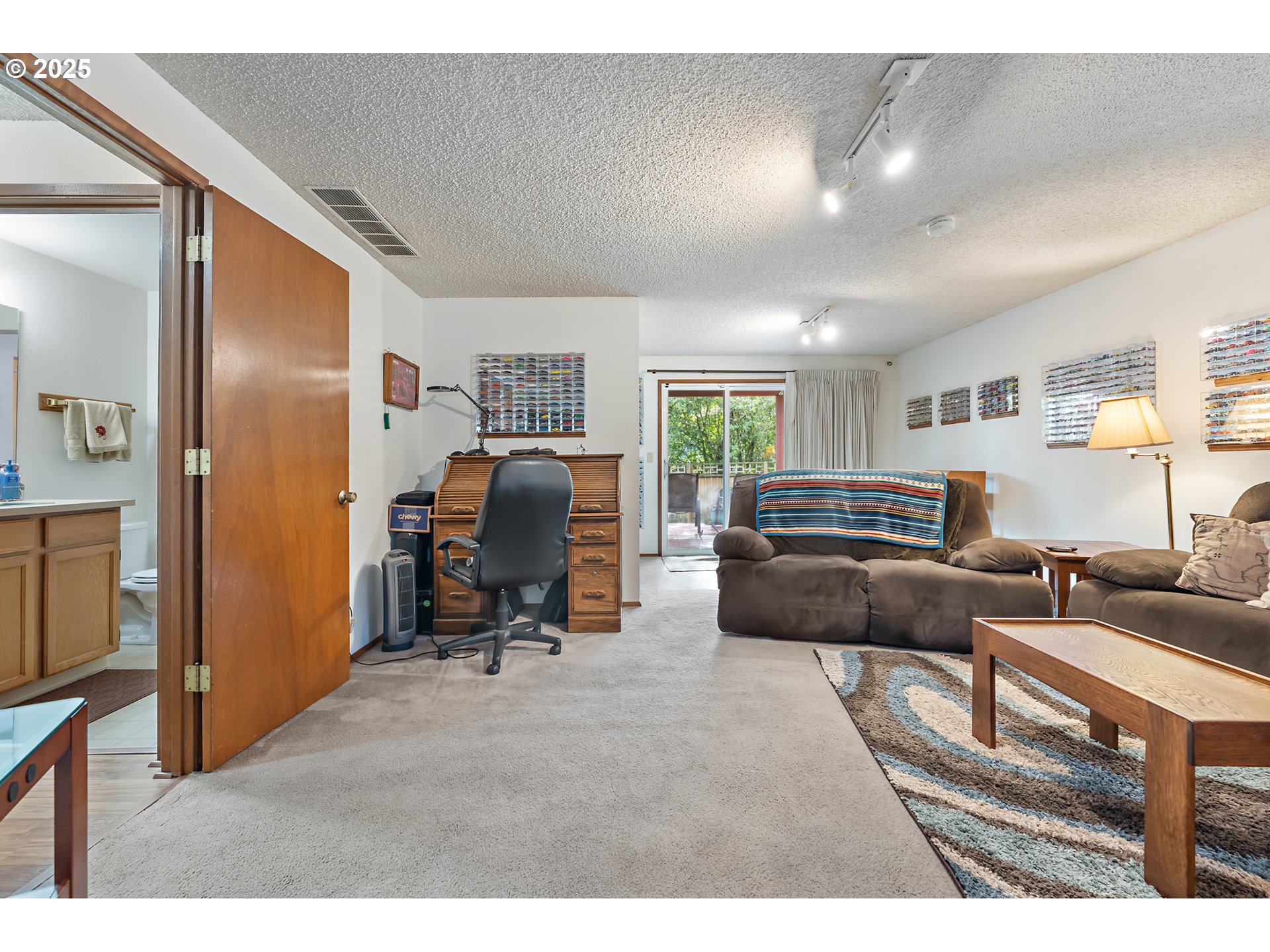 18100 Southwest Barcelona Way Beaverton, OR 97007 - Photo 24 of 41 a living room with furniture and a gym machine