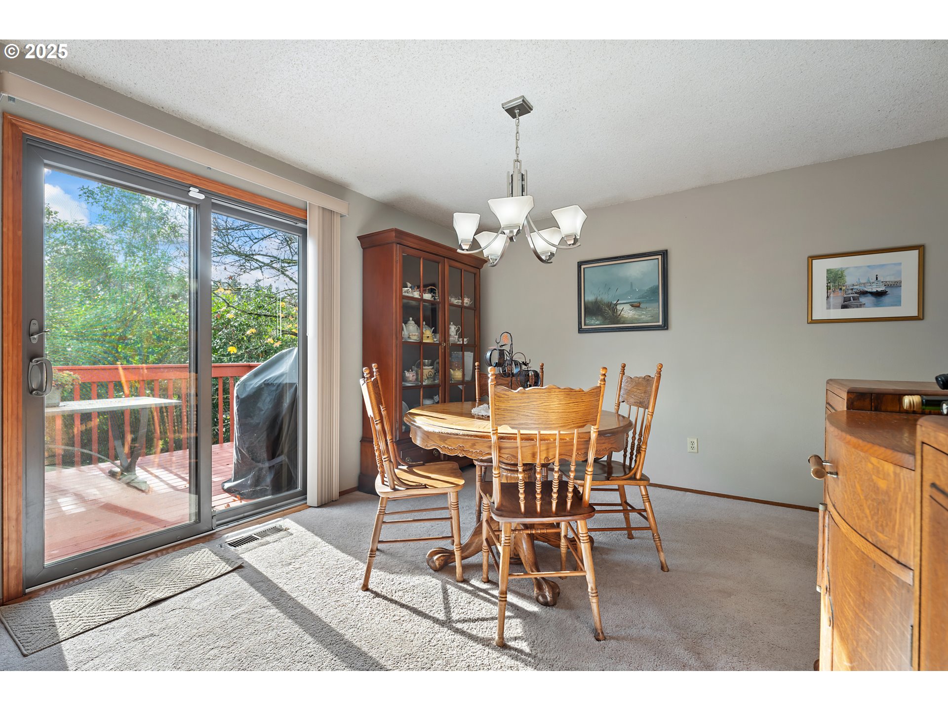 18100 Southwest Barcelona Way Beaverton, OR 97007 - Photo 10 of 41 a dining room with furniture a chandelier and wooden floor