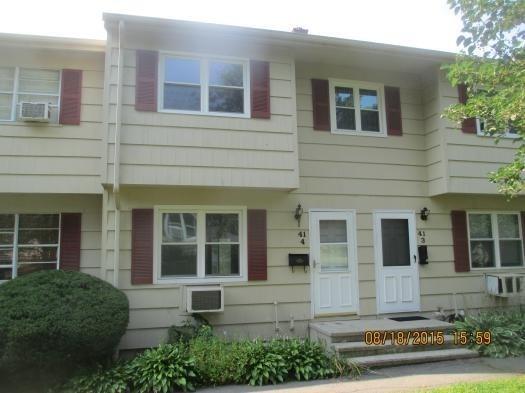 a front view of a brick house with a yard