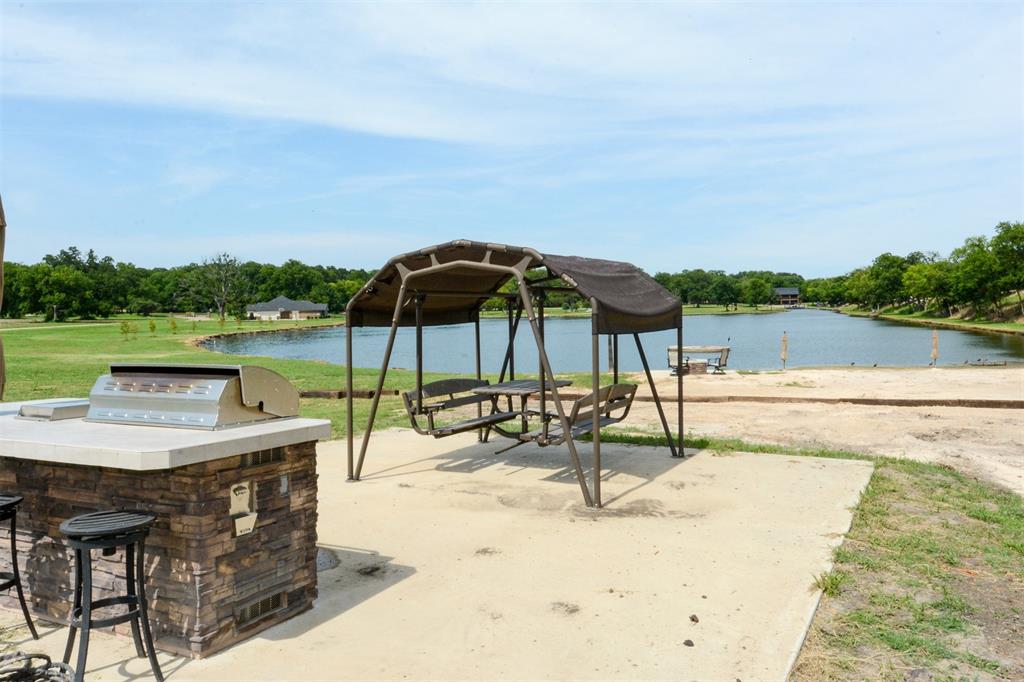 1183 Beacon Shr Road Kemp, TX 75143 - Photo 5 of 16 a view of a lake with a table and chairs under an umbrella