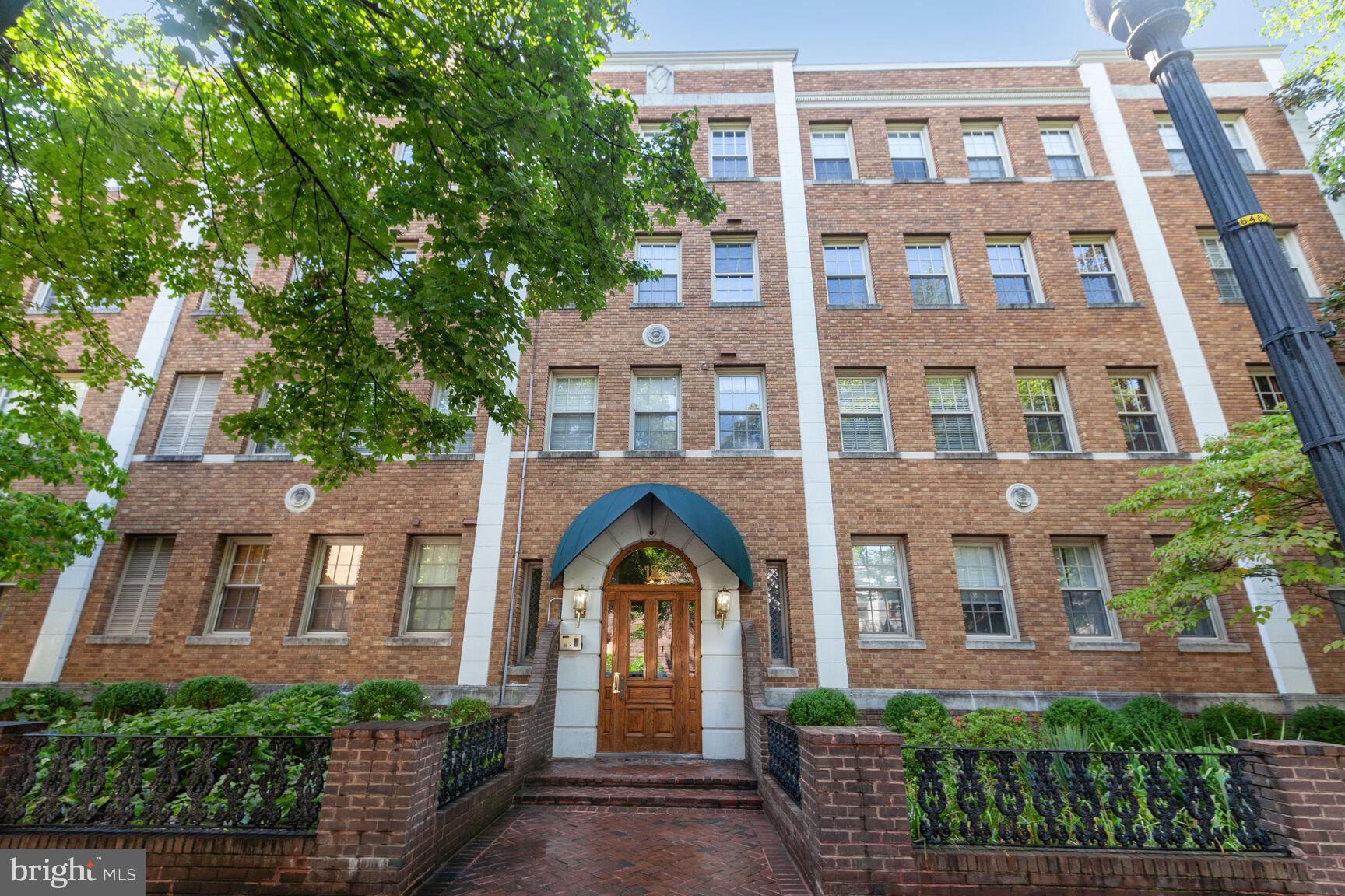a view of a brick building next to a yard