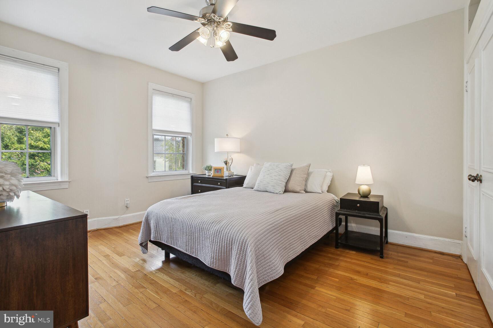 18 9th Street Northeast, Unit 401 Washington, DC 20002 - Photo 12 of 16 a bedroom with a bed and wooden floor