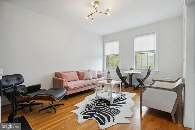 a living room with furniture a rug and a window