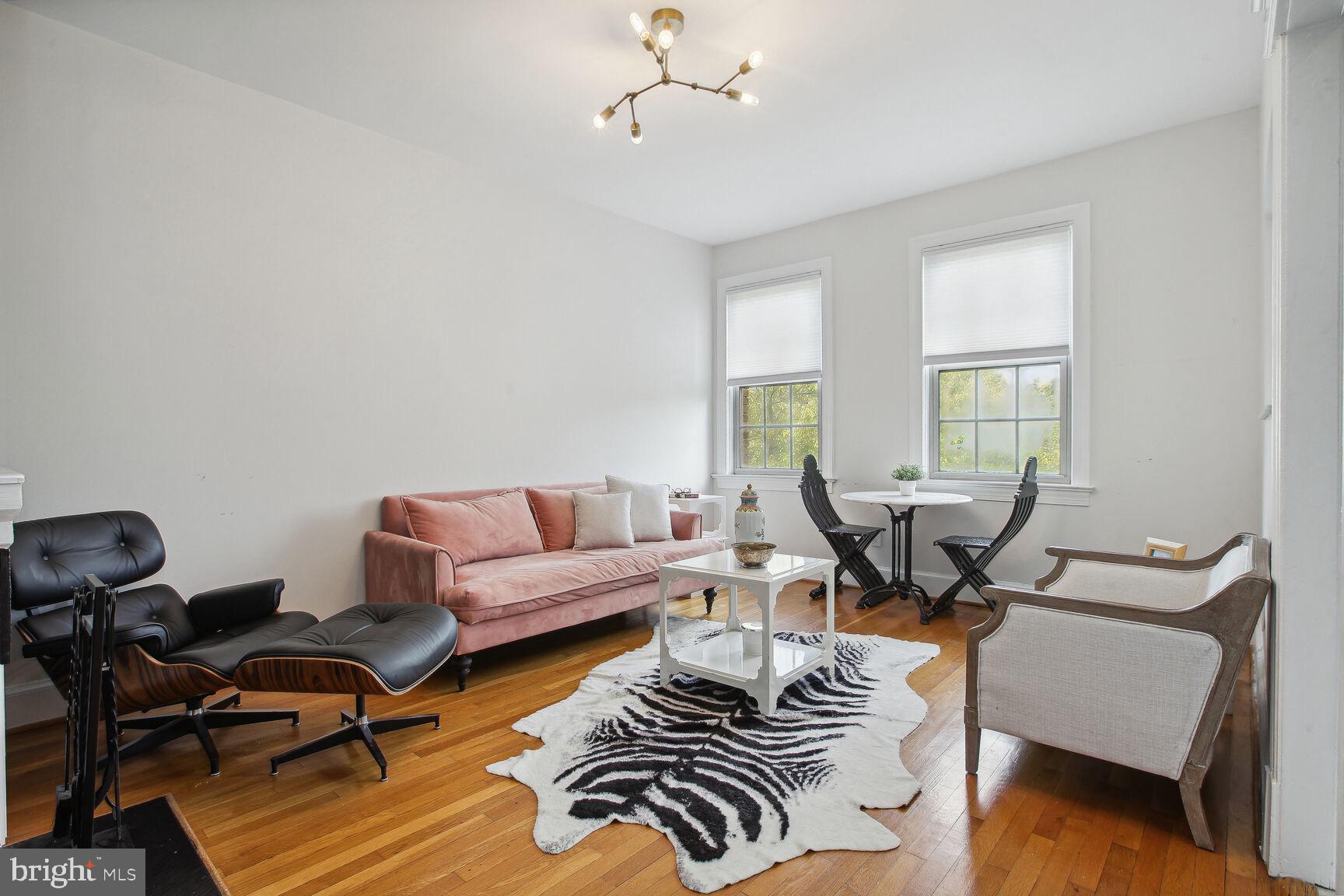 18 9th Street Northeast, Unit 401 Washington, DC 20002 - Photo 8 of 16 a living room with furniture a rug and a window