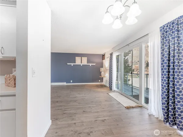 a view of a refrigerator in kitchen and wooden floor