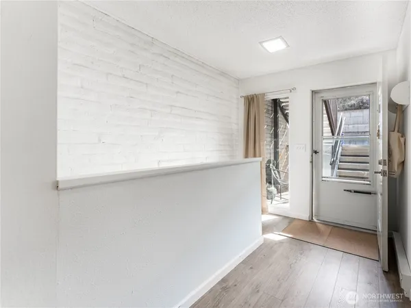 a view of a balcony with wooden floor and a potted plant