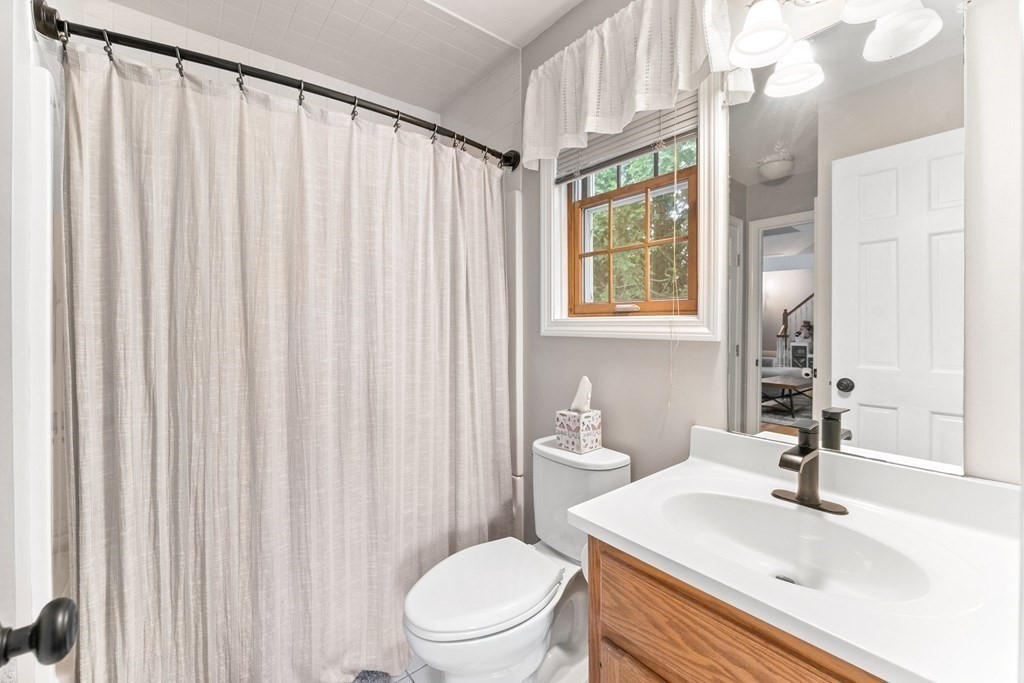 9 Bailin Drive Worcester, MA 01604 - Photo 17 of 30 a bathroom with a sink a toilet and shower curtain