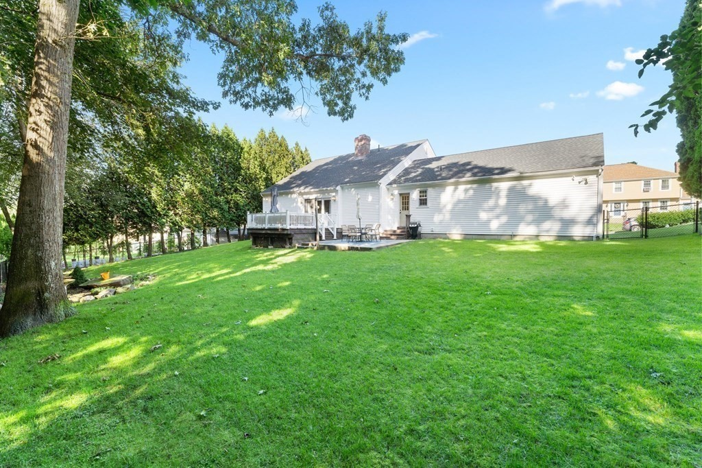 9 Bailin Drive Worcester, MA 01604 - Photo 3 of 30 a house that is sitting in the grass with large trees and plants