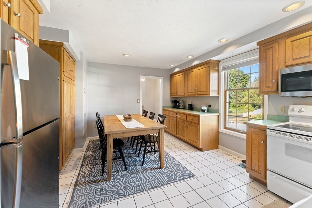 9 Bailin Drive Worcester, MA 01604 - Photo 10 of 30 a kitchen with stainless steel appliances granite countertop a stove a sink a microwave and a refrigerator