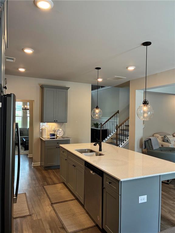 161 Donovan Avenue Locust Grove, GA 30248 - Photo 12 of 42 a kitchen with a sink a counter top space stainless steel appliances and cabinets