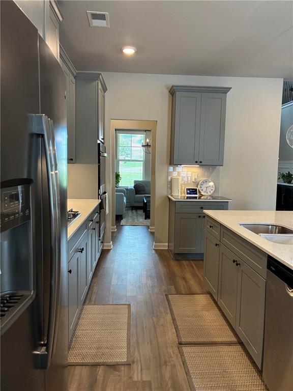 161 Donovan Avenue Locust Grove, GA 30248 - Photo 13 of 42 a kitchen with stainless steel appliances granite countertop a refrigerator and a sink