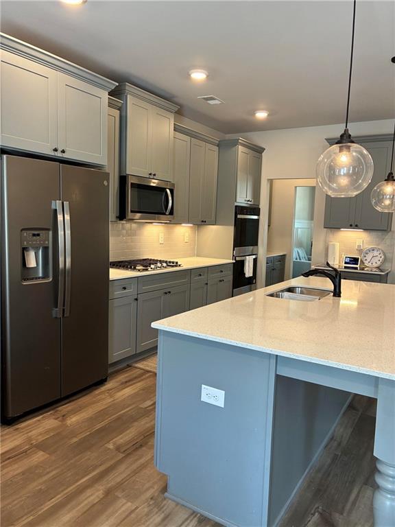 161 Donovan Avenue Locust Grove, GA 30248 - Photo 14 of 42 a kitchen with kitchen island a counter top space stainless steel appliances and cabinets