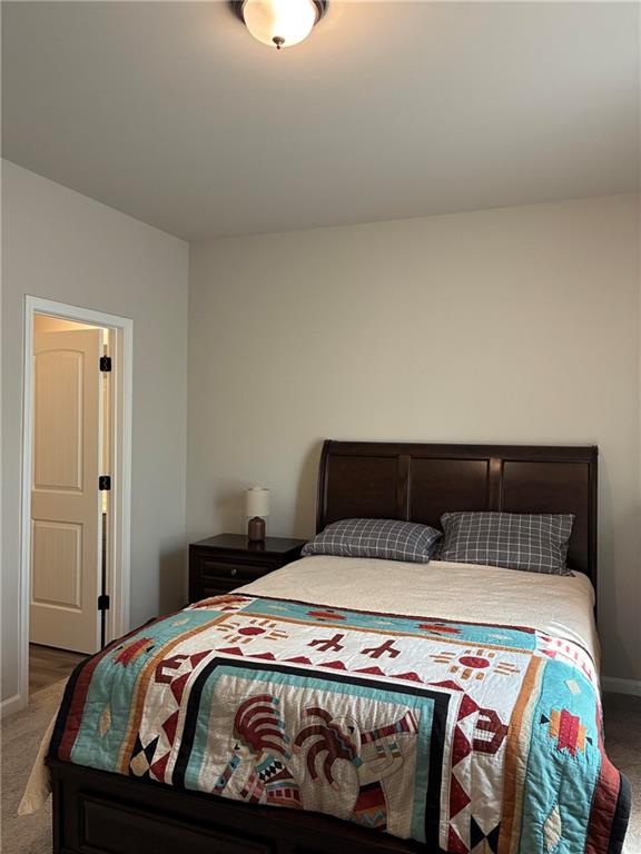 161 Donovan Avenue Locust Grove, GA 30248 - Photo 20 of 42 a bedroom with a bed and a mirror