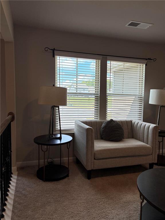 161 Donovan Avenue Locust Grove, GA 30248 - Photo 25 of 42 a living room with furniture and a lamp