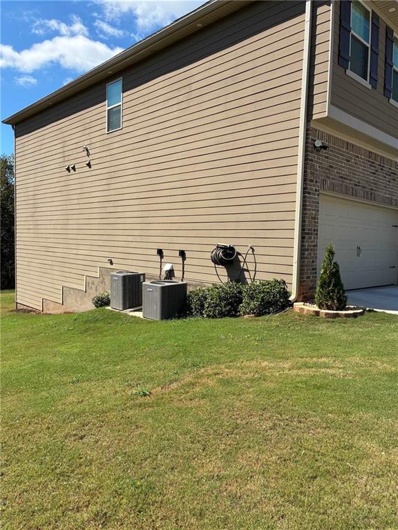 161 Donovan Avenue Locust Grove, GA 30248 - Photo 6 of 42 a view of a backyard with plants and brick wall