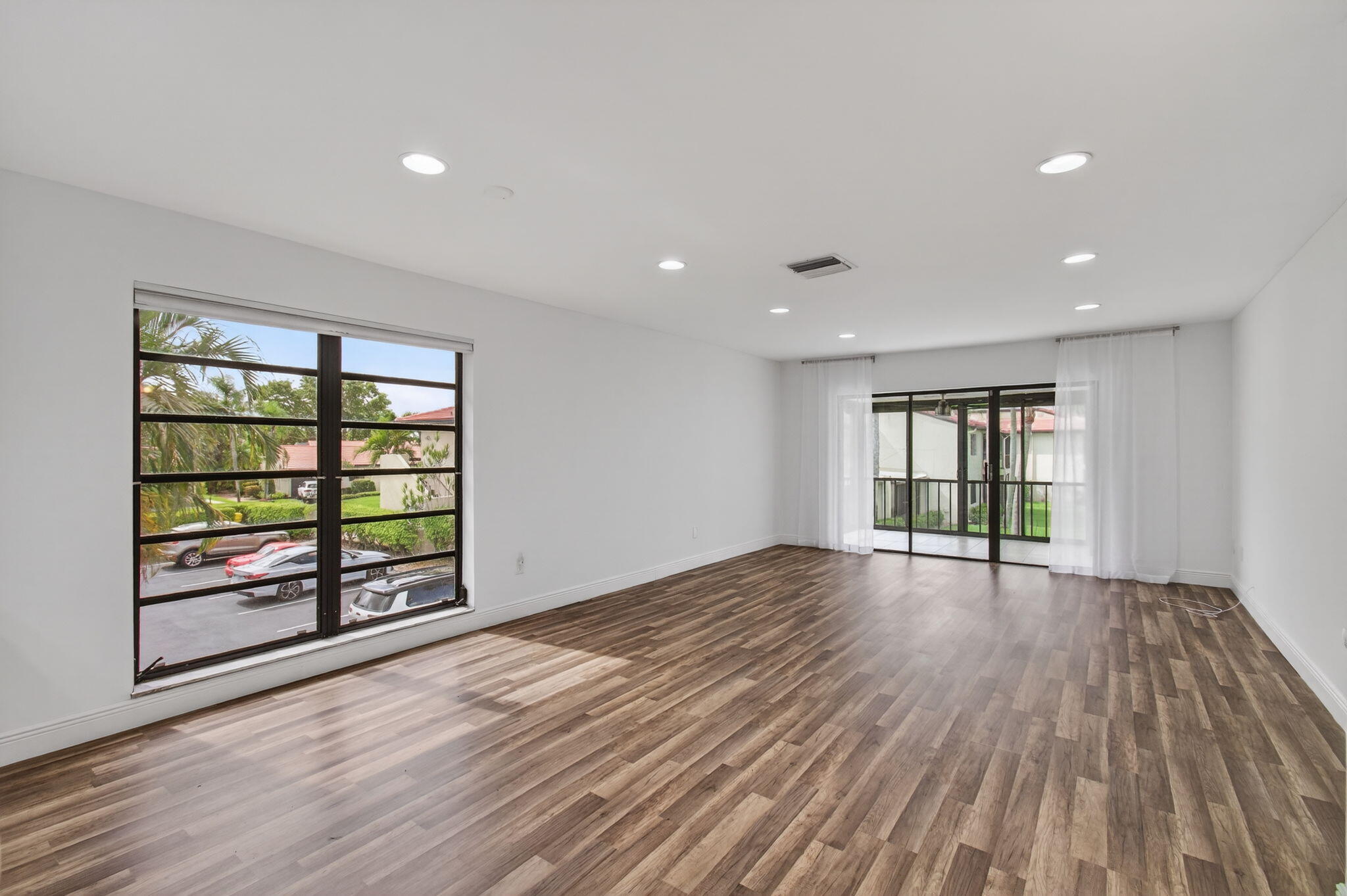 8536 Casa Del Lago, Unit 49B Boca Raton, FL 33433 - Photo 10 of 79 wooden floor in an empty room with a window