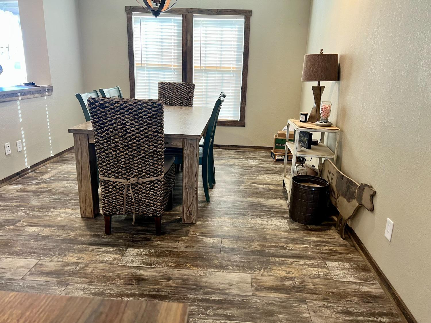 1021 Avenue North Ralls, TX 79357 - Photo 13 of 29 a dining room with furniture and wooden floor
