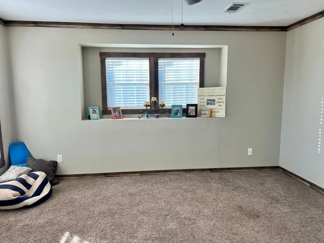 a view of an empty room with windows