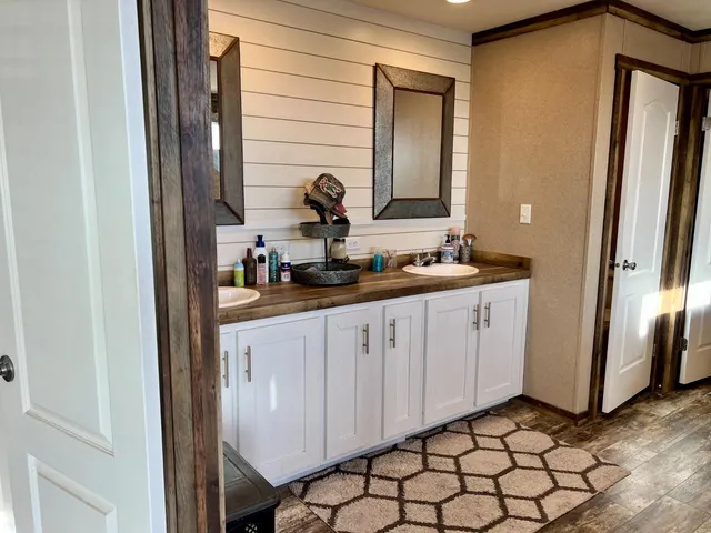 a bathroom with a double vanity sink and a mirror