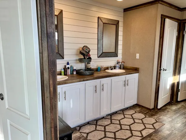 a bathroom with a double vanity sink and a mirror
