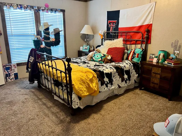 a bedroom with bed and a window